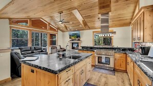 A spacious kitchen with wooden cabinets, a large island, and a built-in oven.