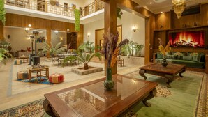 A spacious lobby with a high ceiling, a central fireplace, and multiple seating areas. - Riad Azia: Serenity in Marrakech Your Oasis Awaits! 🌺 (Marrakech)
