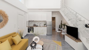Un intérieur moderne comprenant un espace de vie, une cuisine et un escalier.