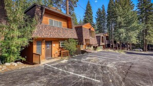 A row of cabins with a parking lot in front, surrounded by tall pine trees. - Near golf course with summer pool (GR14) (Incline Village)