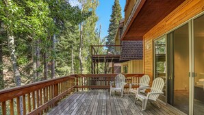 A wooden deck with Adirondack chairs, surrounded by trees. - Near golf course with summer pool (GR14) (Incline Village)