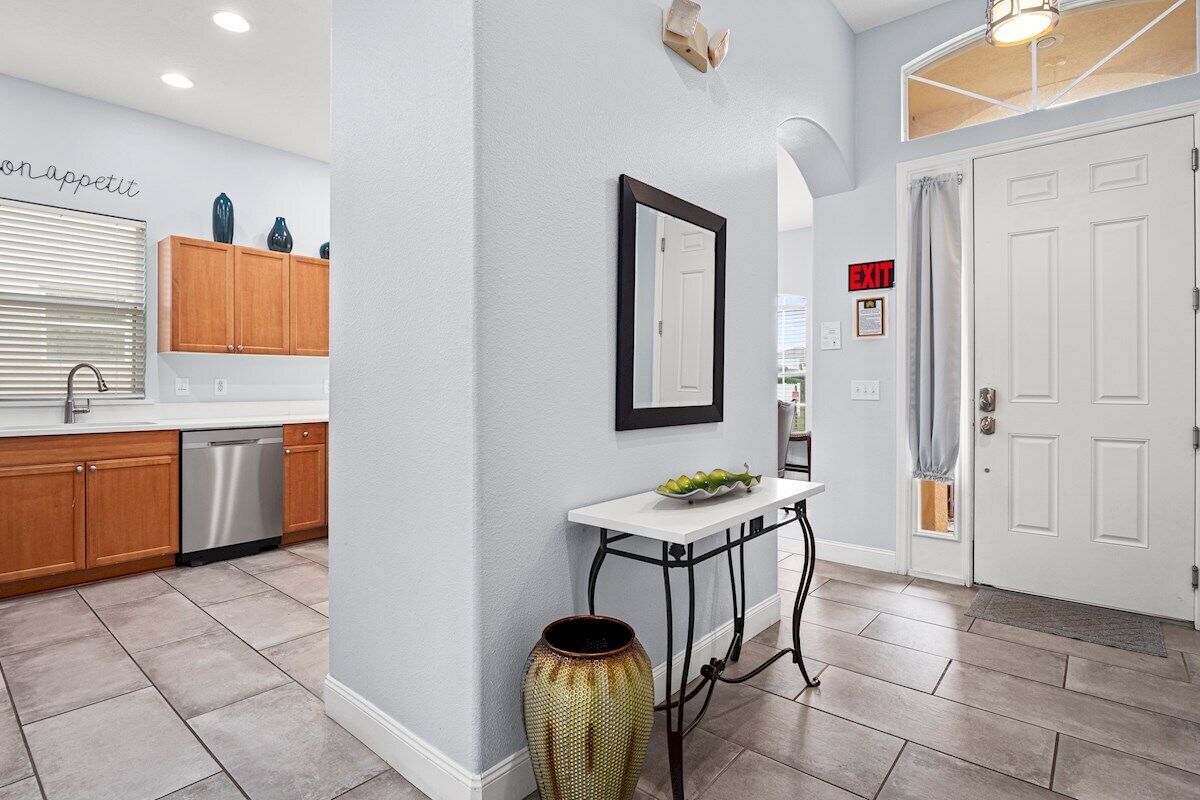 A modern kitchen with wooden cabinets, a dishwasher, and a white countertop.