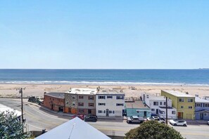 A coastal street with buildings, a beach, and the ocean. - Overlooking the Ocean! (Aptos)