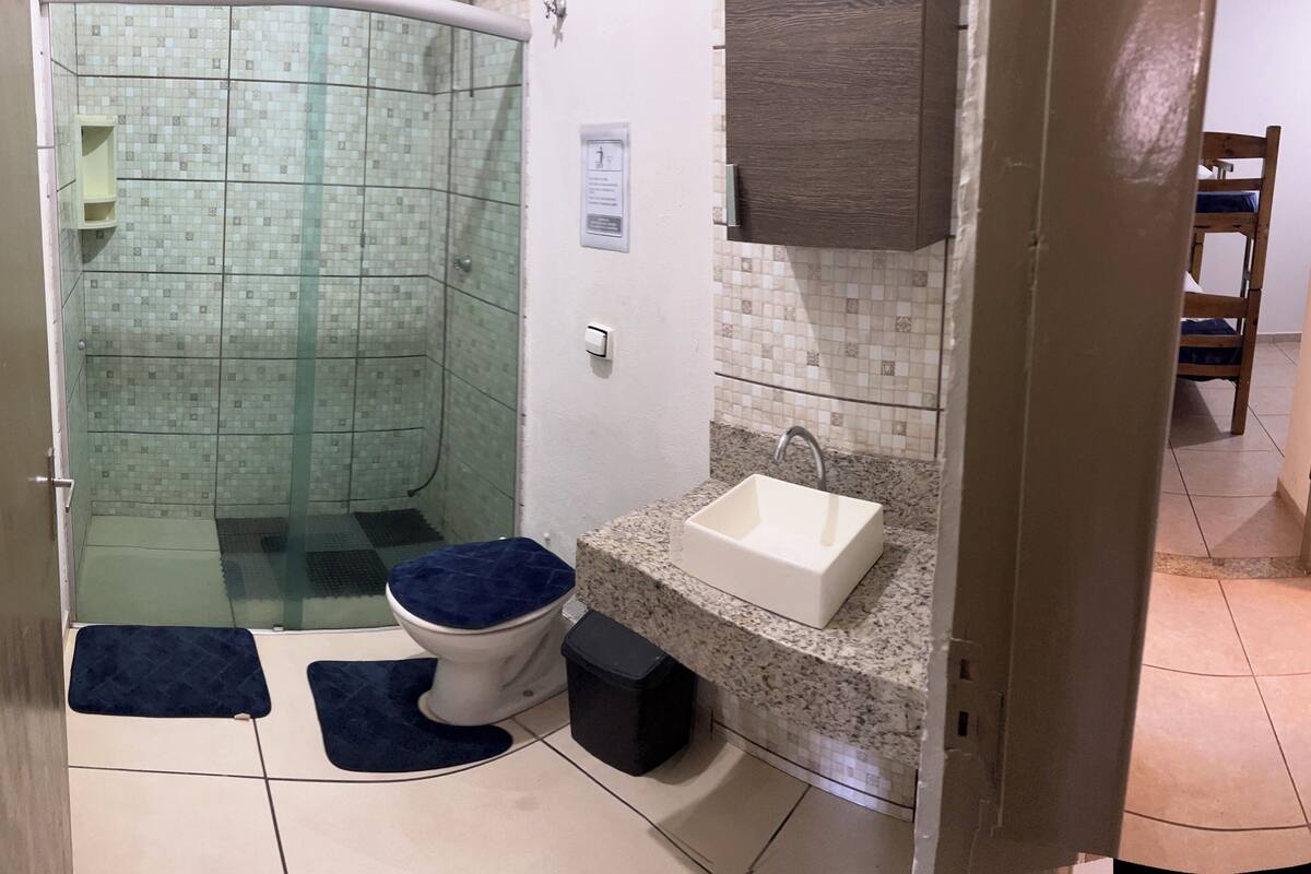 A bathroom with a shower, toilet, and sink.