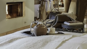 A cozy room with a bed, a chair, a table with a teapot and cup, and a window with curtains. - La Ferme Authentique Ferme Rénovée, Dans un Cadre Champêtre (Praz-sur-Arly)