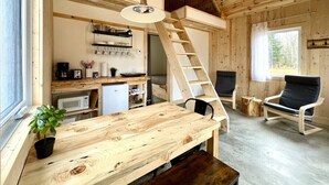 Interior de madera con cocina, comedor y zona de estar.