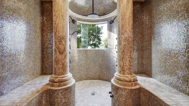 A circular room with mosaic walls and columns, a skylight, and a view of trees outside. - Boerne Hacienda with Pool and Spa (Boerne)