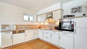 Fridge, stovetop, dishwasher, coffee/tea maker