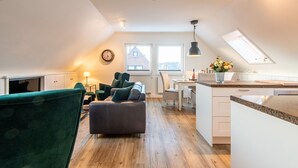 Un appartement moderne de style « loft » comprenant un coin repas, une cuisine et un espace de vie.