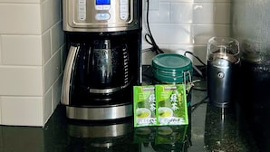 A kitchen with a coffee maker, a kettle, and a mug rack. - Downtown Home Away from Home 3BR/3BA (Rochester)