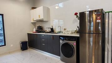 Full-size fridge, cookware/dishes/utensils, cleaning supplies