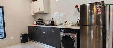 Full-size fridge, cookware/dishes/utensils, cleaning supplies