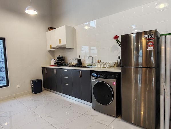 Full-sized fridge, cookware/dishes/utensils, cleaning supplies