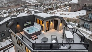 A modern building with a hot tub and outdoor seating on the rooftop. - Luxe Park City Ski-In/Ski-Out Retreat (Park City)