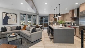 A modern kitchen with a central island, stainless steel appliances, and pendant lighting. - Luxe Park City Ski-In/Ski-Out Retreat (Park City)