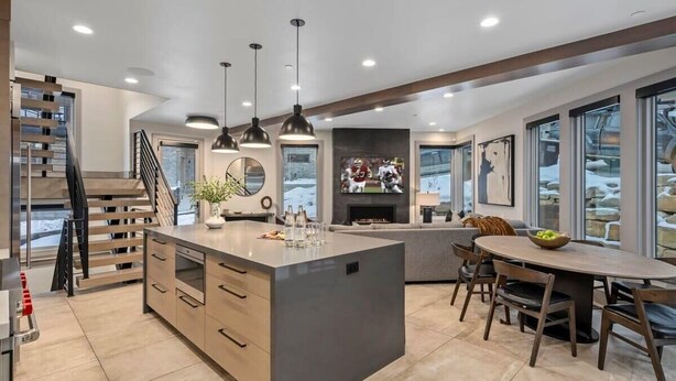A modern kitchen with a central island, pendant lighting, and a fireplace. - Luxe Park City Ski-In/Ski-Out Retreat (Park City)