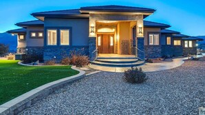 A two-story house with a stone facade, a front porch, and a driveway. - Highland Heights! Luxe Mountain VIEWS w/ Hot Tub (Colorado Springs)