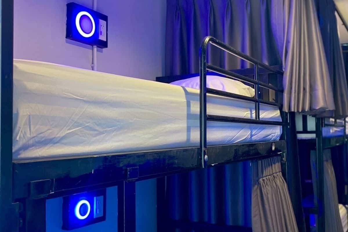 A bunk bed room with a control panel and curtains.