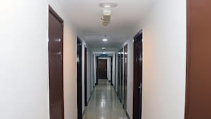 A long, narrow hallway with doors on both sides, leading to a room labeled "RECEPTION". - Hotel Seri Putra  (Kuala Lumpur)