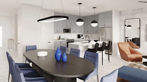 A modern kitchen with white cabinets, a central island, and pendant lighting. - Vor5370aa: 4 Bed, Volcano Adventure, Pool (Orlando)
