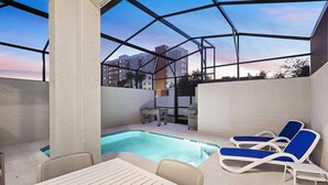 Un espace piscine comprenant des chaises longues, une table et une table de baby-foot.