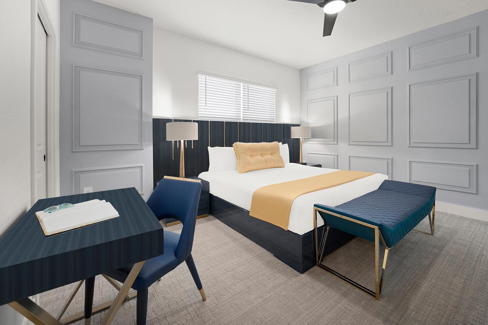 A hotel room with a bed, bedside tables, a desk, a chair, and a bench.