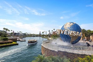 A water body with a boat, a large globe with 'UNIVERSAL' text, and a bridge with decorative railings. - Vor5432aa: 4 Bed, Dragon's Den, Pool (Orlando)