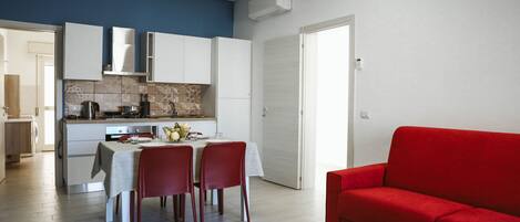 Comfort Apartment | Private kitchen | Full-sized fridge, electric kettle, cookware/dishes/utensils