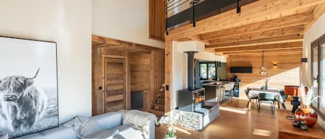 A modern living room with a sofa, a coffee table, and a fireplace.