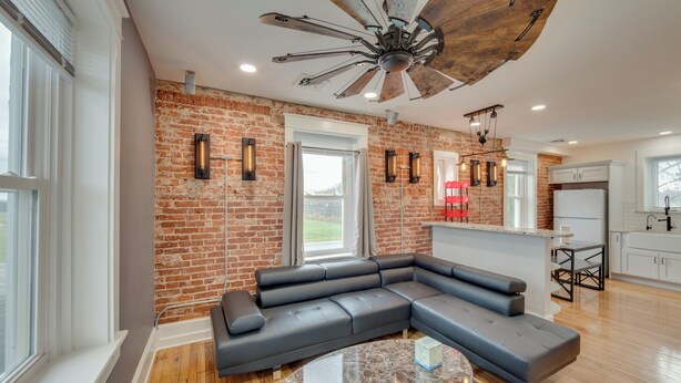 A modern living room with a large L-shaped sectional sofa, a round coffee table, and a ceiling fan. - 15 Mi to Amish Village: Cozy Lancaster Apt! (Lancaster)