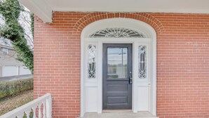 A brick house with a dark gray front door, white trim, and a decorative window above the door. - 15 Mi to Amish Village: Cozy Lancaster Apt! (Lancaster)