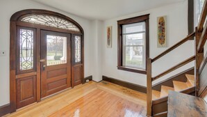 A room with wooden flooring, a staircase, and a door with stained glass panels. - 15 Mi to Amish Village: Cozy Lancaster Apt! (Lancaster)