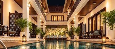 A swimming pool with a view of the building's interior.
