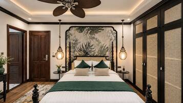 A bedroom with a bed, a ceiling fan, a nightstand, a wall-mounted lamp, and a door.