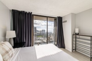 Enjoy a city view from the balcony with a large bed and a desk for work.