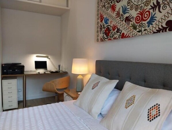 Work in comfort with a spacious bed and a convenient wall-mounted desk.
