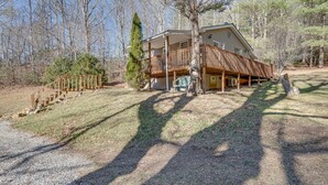 A cabin with a wooden deck, a covered porch, and a gravel driveway. - Lovely Smoky Mountain Cottage w/ Deck + Views! (Topton)