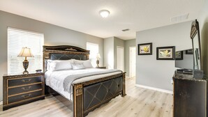 A bedroom with a bed, dresser, and a television on a stand. - ~ 6 Mi to Disney: Kissimmee Vacation Villa w/ Pool (Kissimmee)