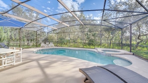 A covered outdoor swimming pool with a pergola, lounge chairs, and a table. - ~ 6 Mi to Disney: Kissimmee Vacation Villa w/ Pool (Kissimmee)