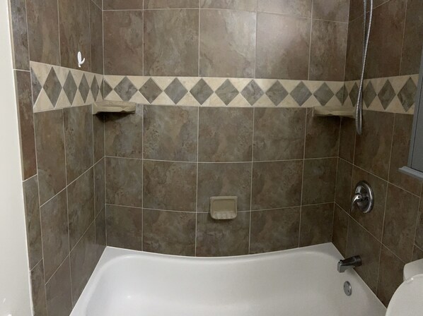 A bathroom with a bathtub, a shower, and a toilet. - capri sun (Naples)