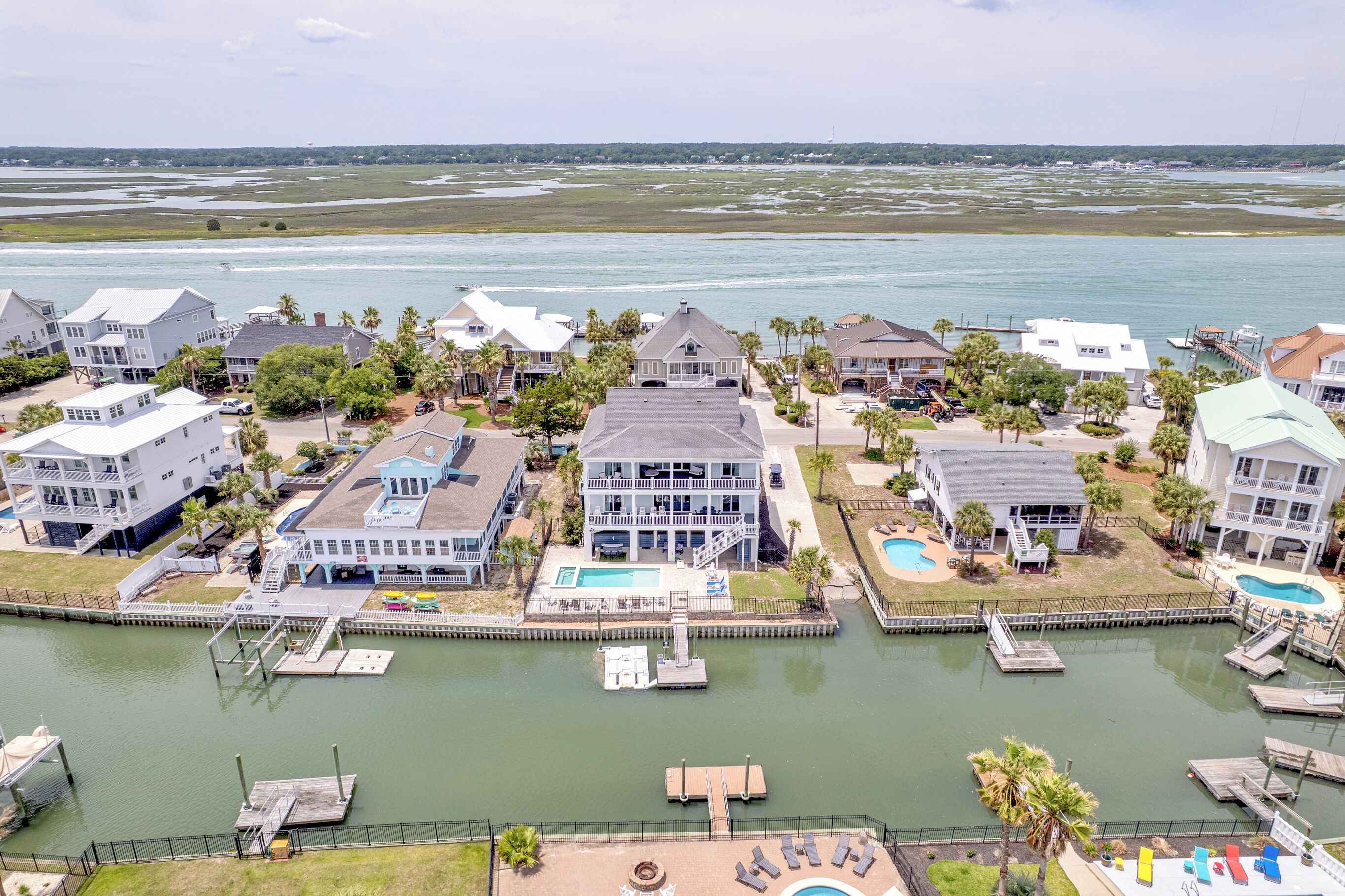A waterfront property with multiple buildings, docks, and a swimming pool.
