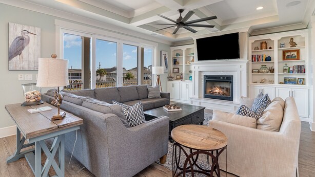 A spacious living room with a sectional sofa, a coffee table, and a fireplace. - Barnacle Bill's: Private Pool w/dock & Ramp (Murrells Inlet)