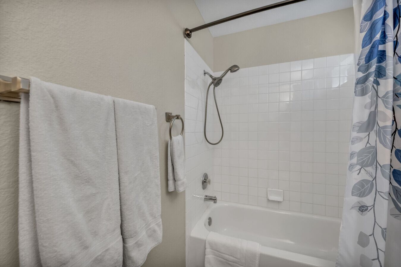 Une salle de bain équipée d’une baignoire, d’une douche et d’un porte-serviettes avec deux serviettes.