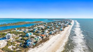 An aerial view of a coastal residential area with houses along a sandy beach and a clear blue ocean. - Pool | Elevator | Sleeps 10 (Cape San Blas)