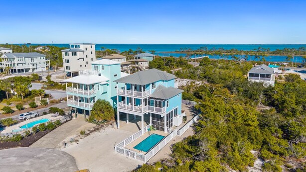 A coastal property with multiple buildings, a swimming pool, and a view of the ocean. - Pool | Elevator | Sleeps 10 (Cape San Blas)