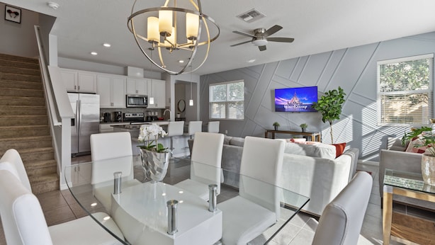 A modern kitchen with white cabinets, a microwave, and a refrigerator.