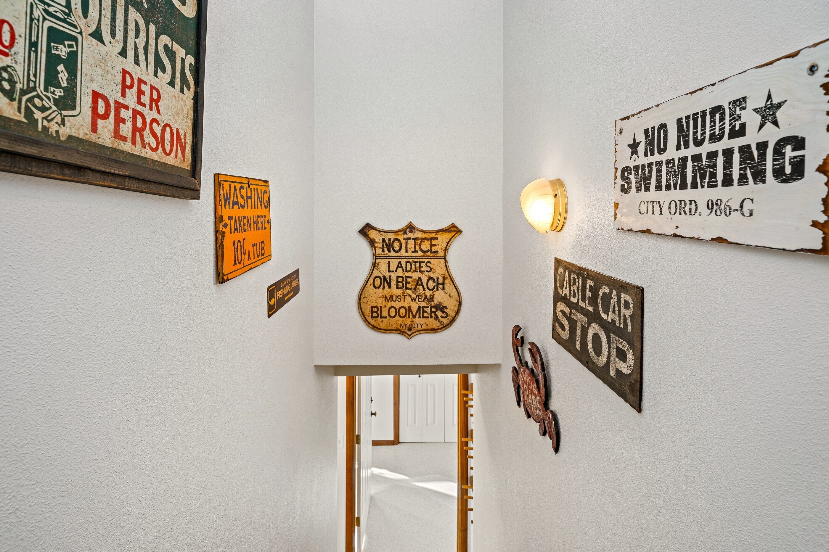A hallway with various signs including 'Notice Ladies On Beach Must Wear Bloomers' and 'No Nude Swimming'.