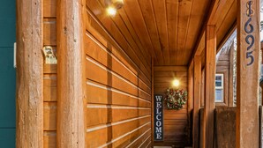 A wooden hallway with a 'WELCOME' sign and a number '695' on the wall. - Golf Course views, Deer in yard, Next to Lake (McCall)