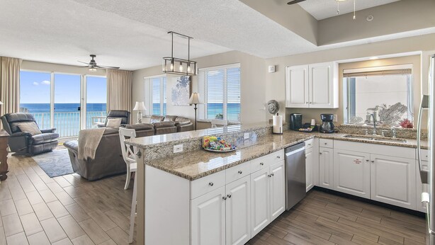 A spacious living area with a large island, a ceiling fan, and a view of the ocean. - Majestic Sun B314*GulfViews*Owner's Garage*Hot Tub*Heated Pools*Beach Gears*Gym (Miramar Beach)