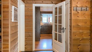 A wooden interior hallway leading to a kitchen with a sink and cabinets. - 4 bedroom awesome home in Nordfjordeid (Nordfjordeid)